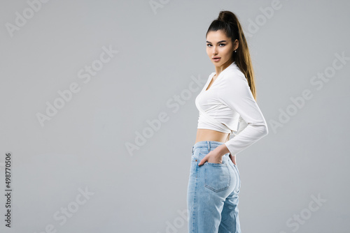 Rear view of woman in jeans isolated on white background