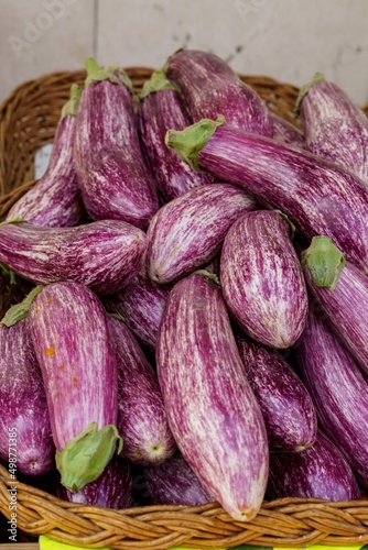 Organic purple eggplants at a market stall. Healthy food