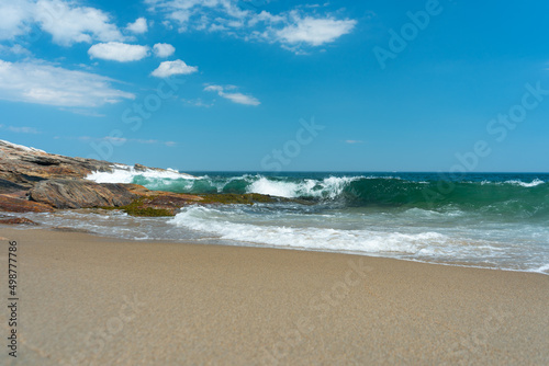 Wave curling onto Maine beach