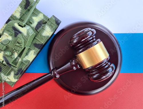 Military tank Russian aggression stand on flag of Russia and judicial gavel