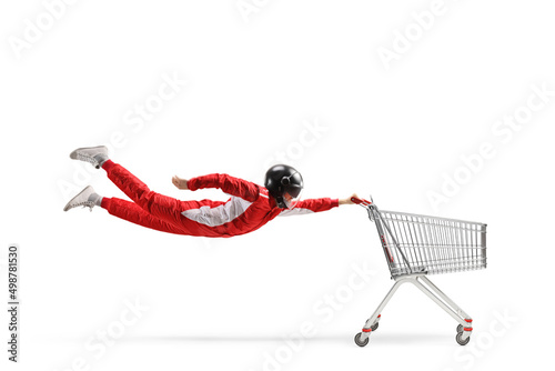 Car racer in a red suit and black helmet flying with an empty shopping cart © Ljupco Smokovski