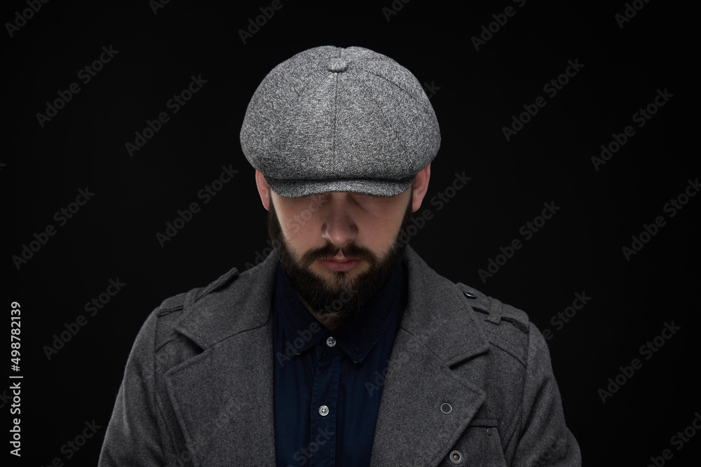 Man with a beard on a dark background, English classic clothes Man with a beard on a dark background, English classic clothes