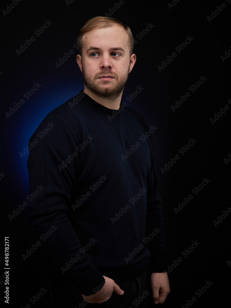 vertical portrait blond man on a dark background, in a jacket vertical portrait blond man on a dark background, in a jacket