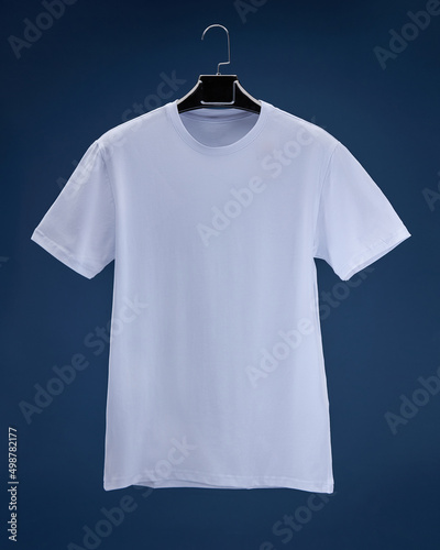 Volume T-shirt hanging on hanger, dark blue background colour white, grey, blue