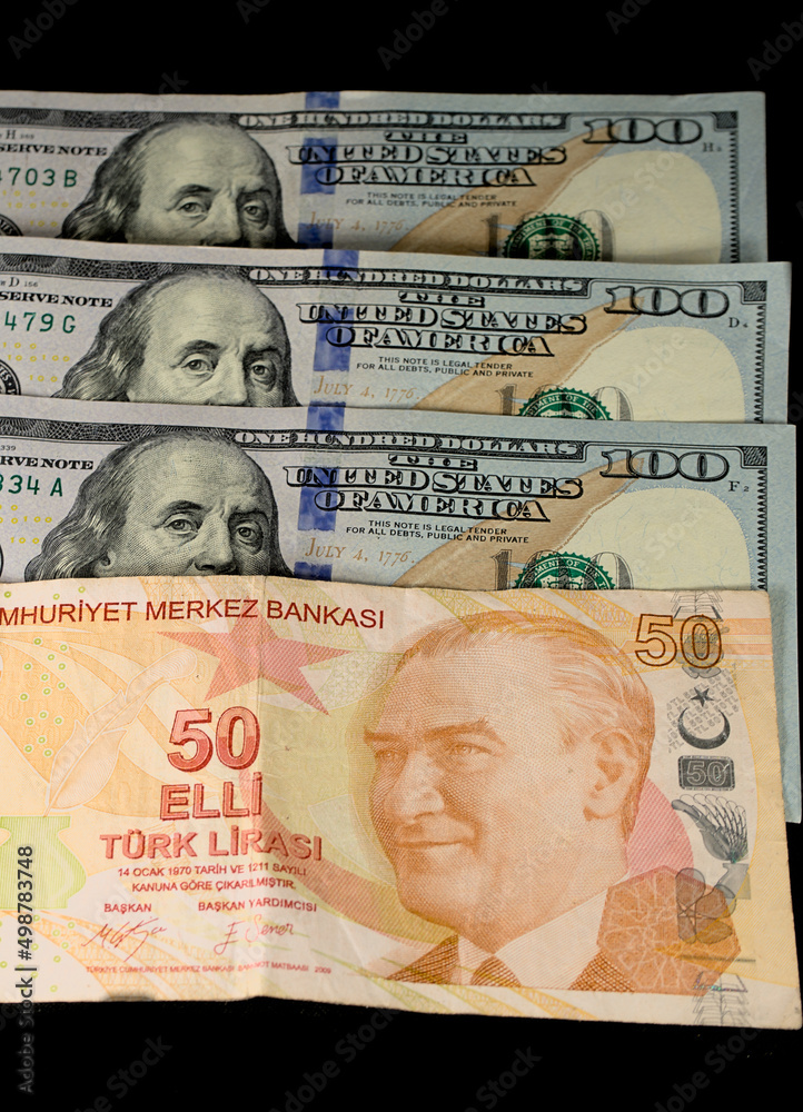 Turkish lira banknotes and American dollars on a black background
