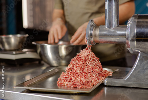 Chopped meat. Chef's Kitchen. The process of preparing minced meat. Stuffing for a restaurant dish. Meat grinder photo