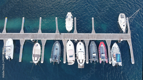 menorca's jetty with many boats and ships, moored on the turquoise water