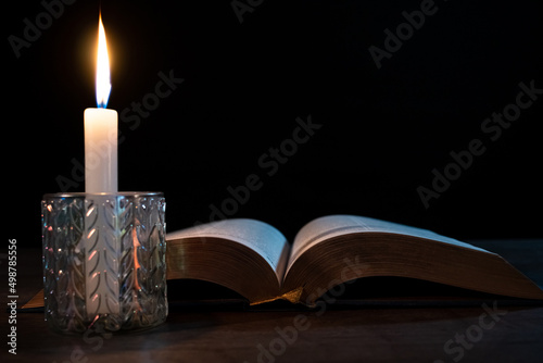 Wallpaper Mural Candle with a book on the table in the dark. Torontodigital.ca