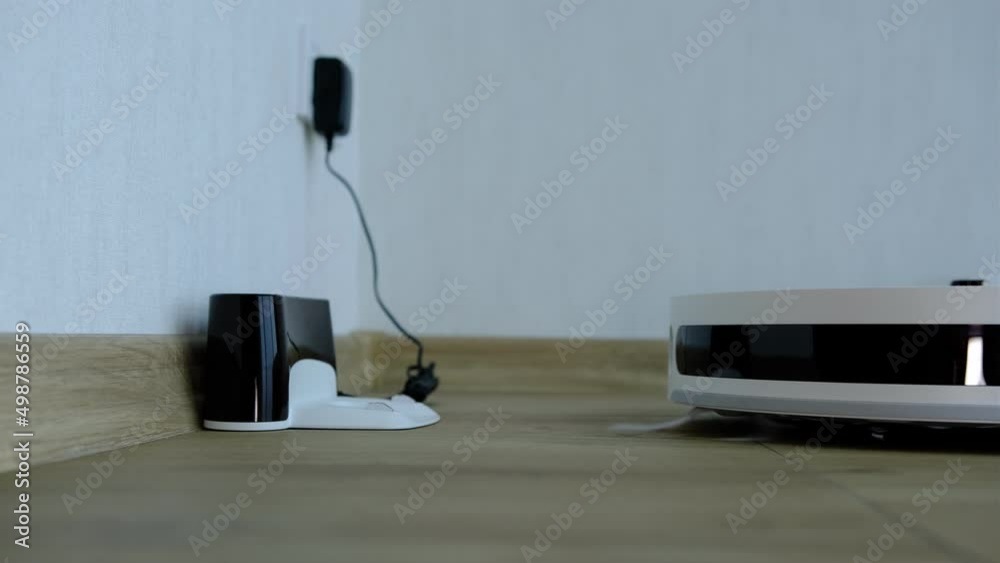 Robotic Vacuum Cleaner Charging Battery Smart Cleaning Technology. Modern smart electronic housekeeping technology Robotic Vacuum Cleaner Charging Battery Smart Cleaning Technology. Modern smart electronic housekeeping technology