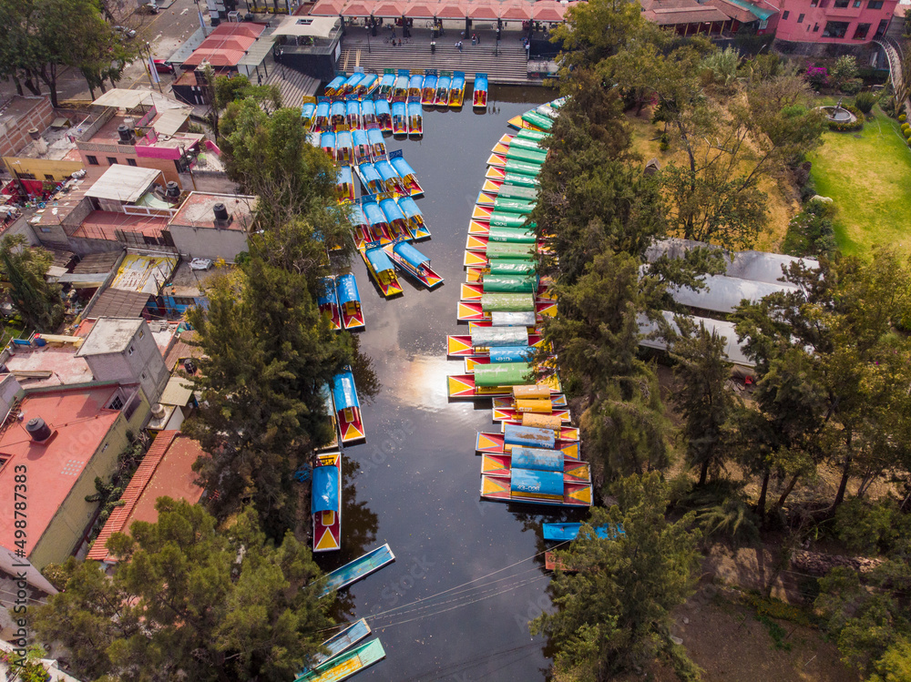 Aerial Drone Shot of Colorful Boats in Xochimilco. Tours by cannels with floating gardens in Mexico City CDMX, Mexico