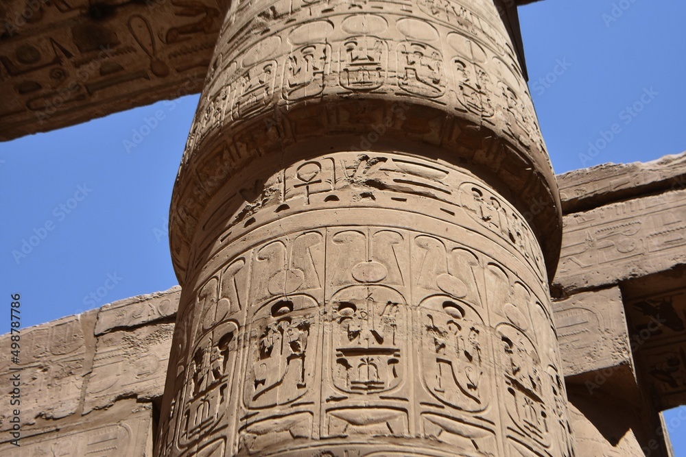 Ancient columns with drawings, in the great hypostyle hall, at the temple of Amon-Re in Karnak, Egypt.