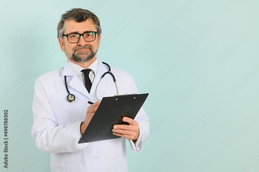Smiling medical senior doctor with a stethoscope. On a blue background. The concept of humanity's victory over disease Smiling medical senior doctor with a stethoscope. On a blue background. The concept of humanity's victory over disease