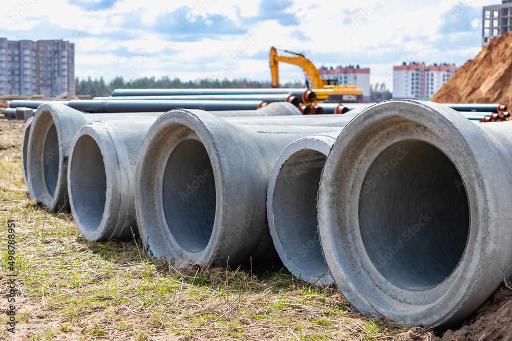 Reinforced concrete storm sewer pipes of large diameter stacked at a ...