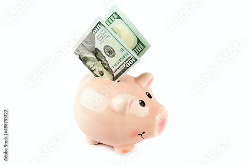 American dollars and piggy bank isolated on white .