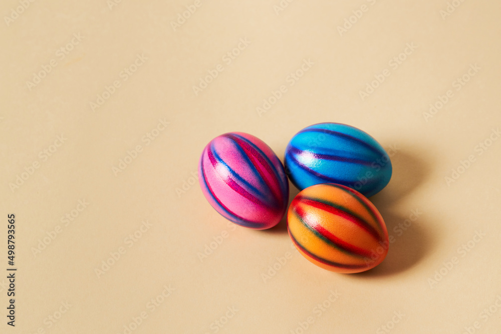 Colorful Easter eggs with on a solid beige background.  Preparation for holiday.