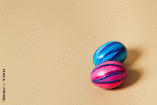 Colorful Easter eggs with on a solid beige background. Preparation for holiday.