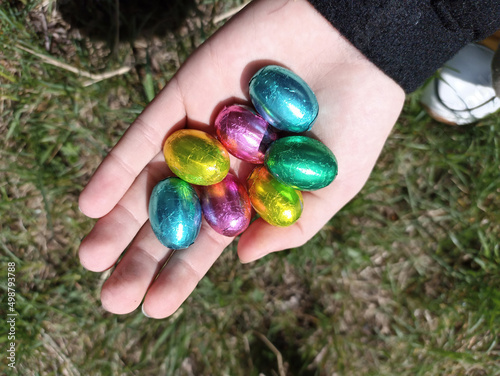 Hand holding multicolored Easter eggs