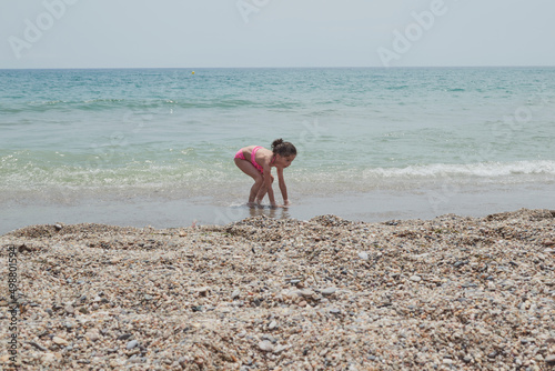 Girl playing happily on the shore of the beach, Vera, Spain