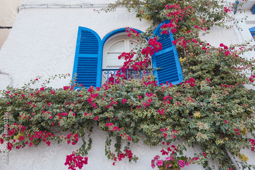 Balcony decorated with flowers on a street in Mojacar, Spain photo