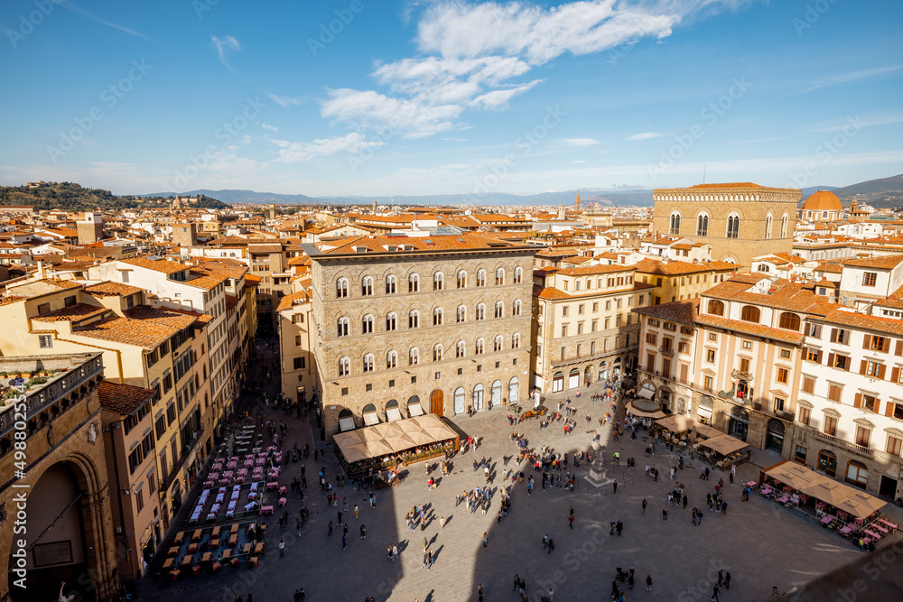 Top view on crowded Signoria square near Vecchio palace on a sunny day in Florence, Italy. Cityscape of most significant city of Tuscany