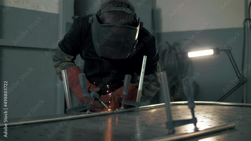 Sparks during welding work in the metal industry. Slow motion. Sparks during welding work in the metal industry. Slow motion.