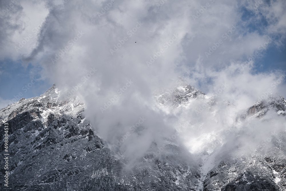 Very cloudy sky over mountains covered with snow near the alps Very cloudy sky over mountains covered with snow near the alps