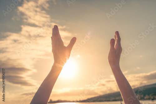 hands up to the sun at dawn, feelings of happiness, hope, and joy
