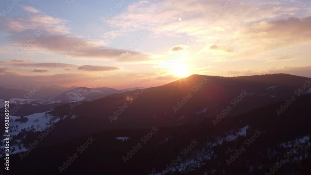 Aerial view of winter sunset over alpine silhouette mountains, Aerial view of winter sunset over alpine silhouette mountains,