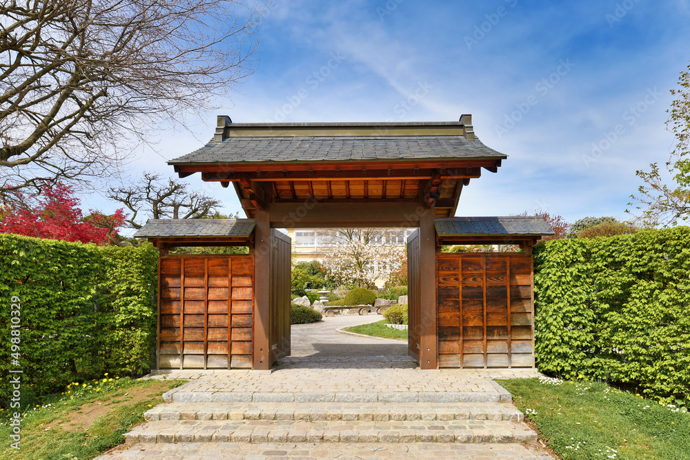 Freiburg, Germany - April 2022: Entrance gate of Japanese garden in public park called 'Seepark' Freiburg, Germany - April 2022: Entrance gate of Japanese garden in public park called 'Seepark'