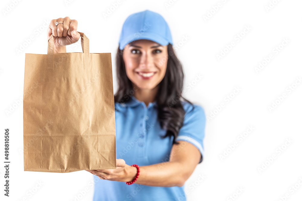 Young dark-haired employee holding a paper takeaway bag in front of her ready for the customer. Isolated background Young dark-haired employee holding a paper takeaway bag in front of her ready for the customer. Isolated background