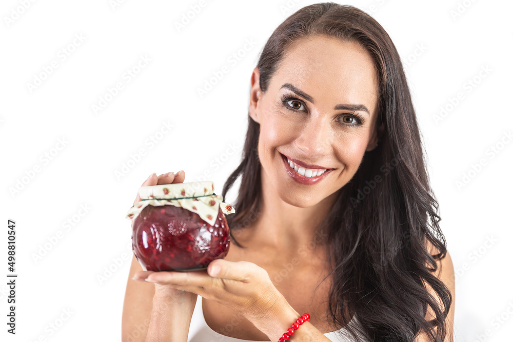 A rustic jar full of tasty jam held by and attractive brunette. Isolated background