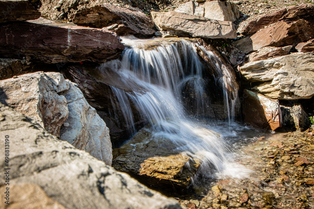 a small waterfall cascades through the rocks a small waterfall cascades through the rocks