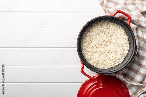 Uncooked Carnaroli risotto rice in pot.