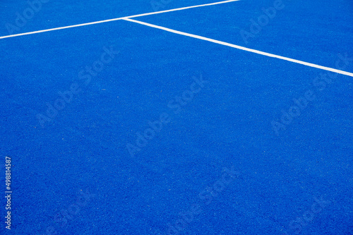 blue artificial grass paddle tennis court, racket sports concept © Vic