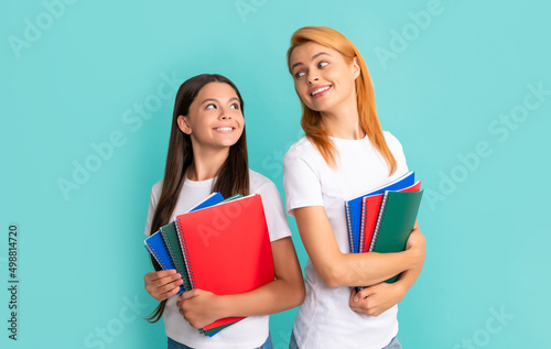 cheerful school pupil and student holding notebooks, back to school