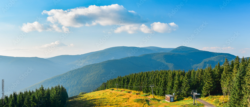 Mountain landscape in High Jesenik, view of the mountain range from the lookout tower on Medvedi Mountain, sunny day.