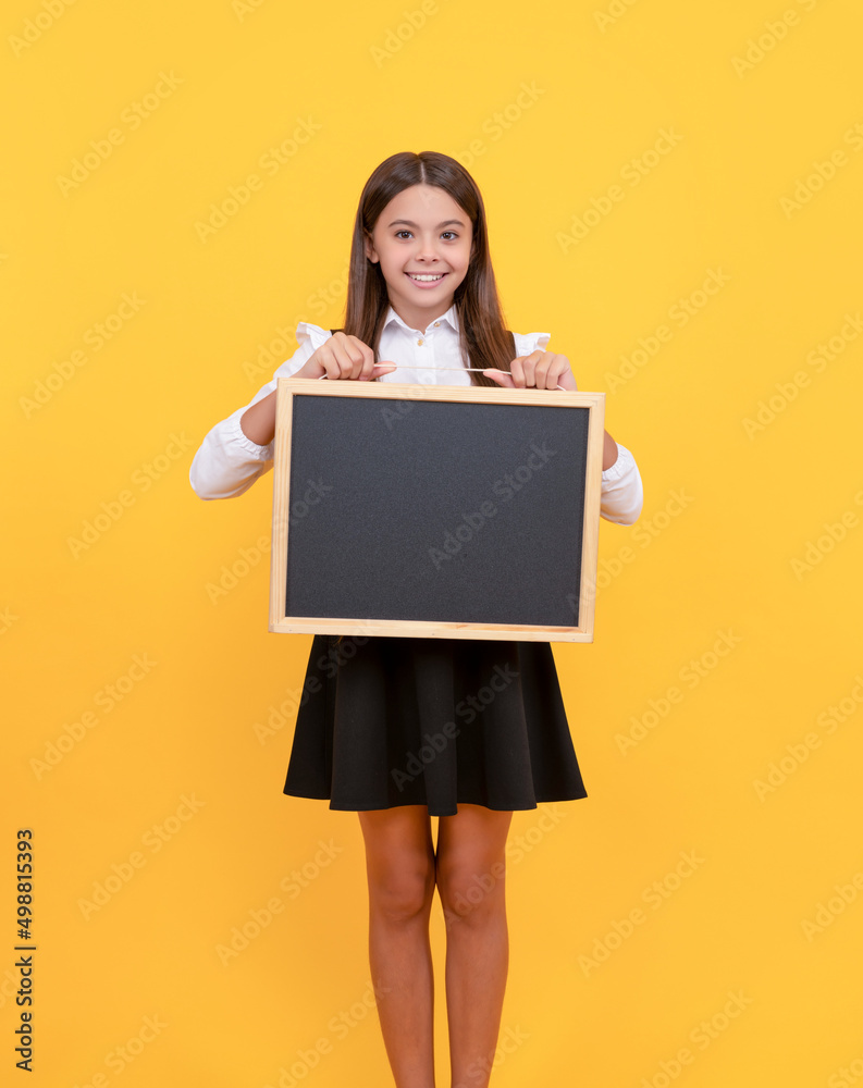 happy teen girl hold blackboard. child advertising. back to school. presenting novelty information happy teen girl hold blackboard. child advertising. back to school. presenting novelty information