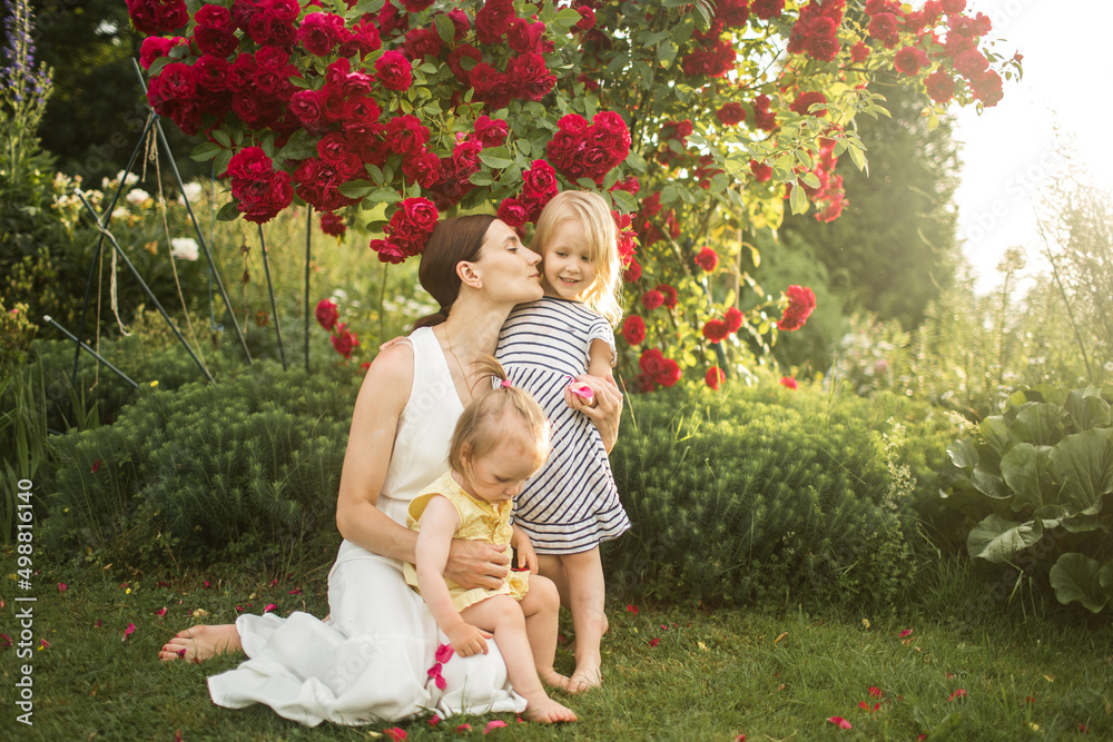 mother hugs her daughter, relax, collect a bouquet of roses
