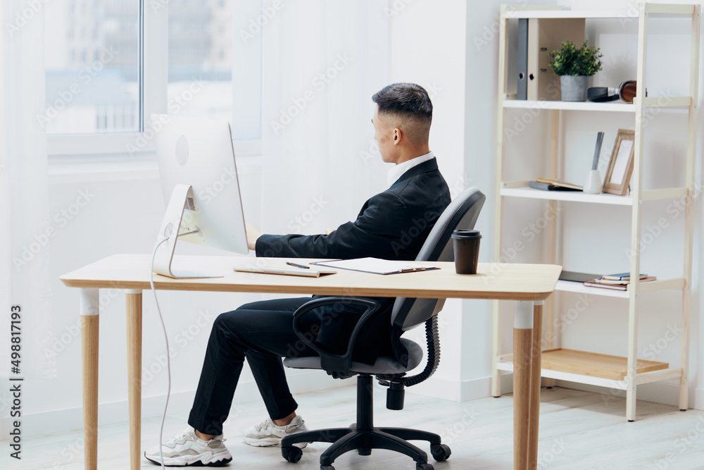 manager sitting at a desk in front of a computer emotions Workspace manager sitting at a desk in front of a computer emotions Workspace