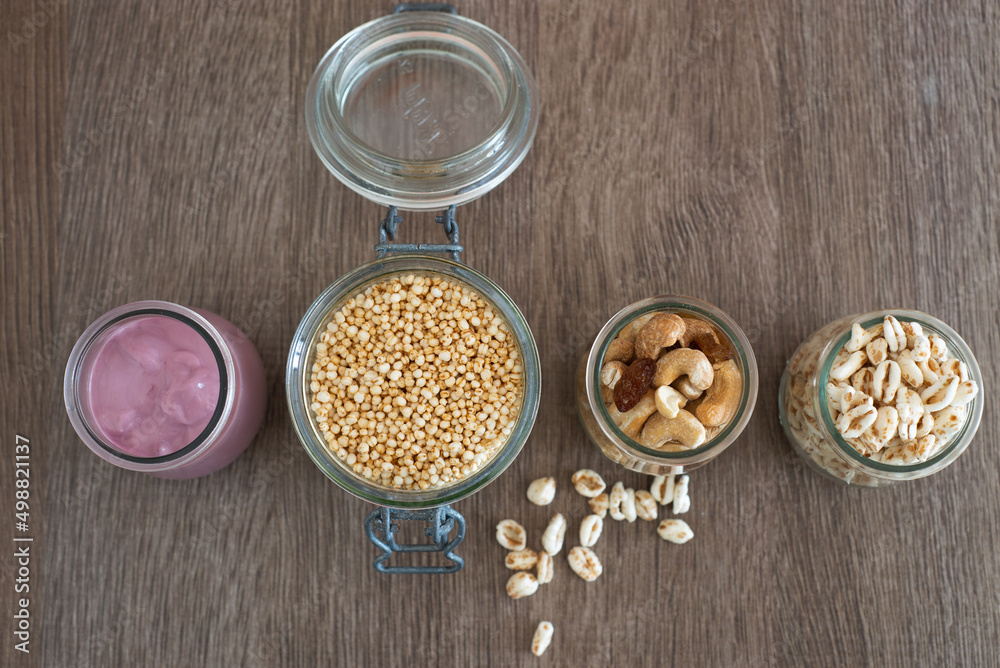 Jars with fresh yogurt, macadamia nuts , puffed oats and puffed quinoa Jars with fresh yogurt, macadamia nuts , puffed oats and puffed quinoa