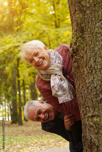Senior couple laughing and having fun in autumn park. Age is no barrier to fun