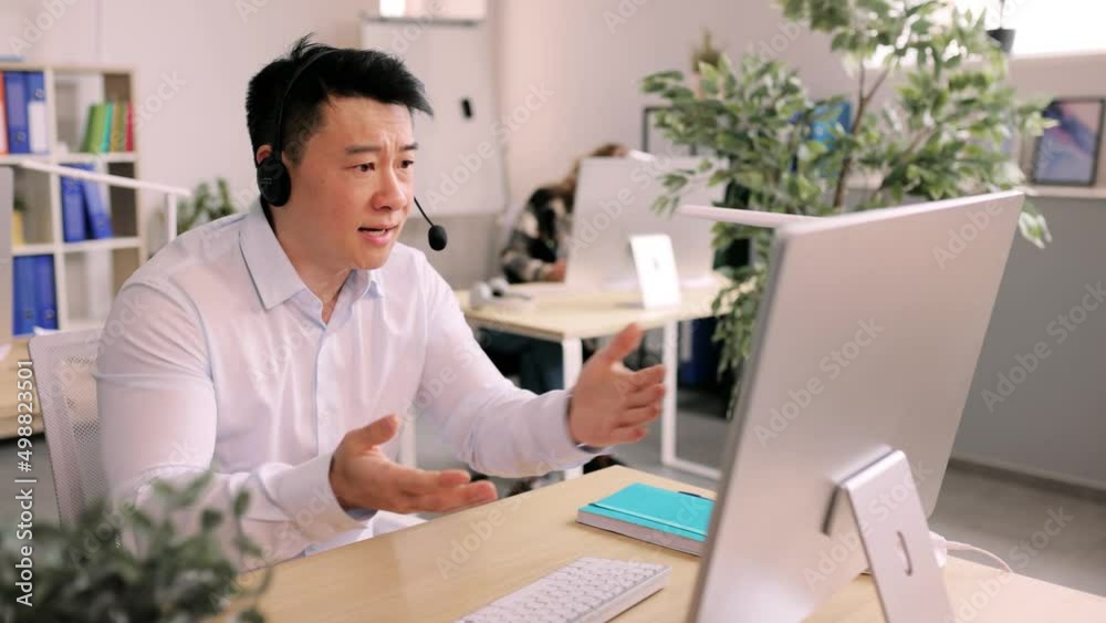 Portrait of angry man shows a fists and talking by video chat at the modern office. Aggressive male making video call on computer. . High quality 4k footage Portrait of angry man shows a fists and talking by video chat at the modern office. Aggressive male making video call on computer. . High quality 4k footage