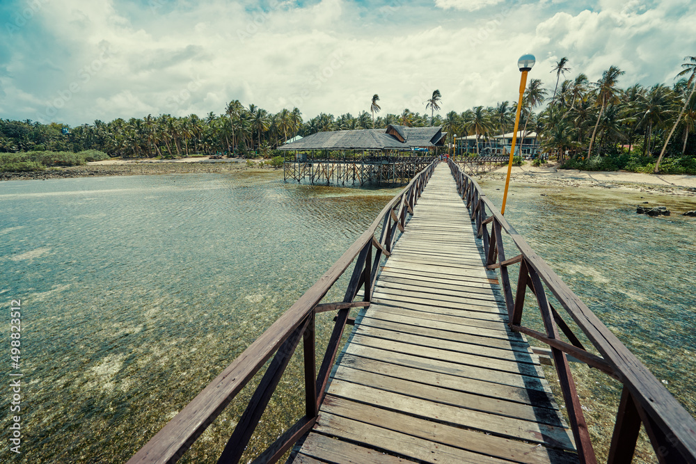 Naklejka premium Beautiful landscape. Sunny day on seashore. Wooden bridge on Cloud 9 beach, Siargao Island Philippines.