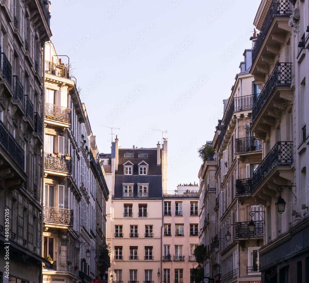 Parisian street with rays of the rising sun