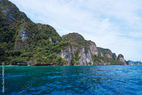 Traveling by Thailand. Beautiful seascape with rock and cliff in blue lagoon.