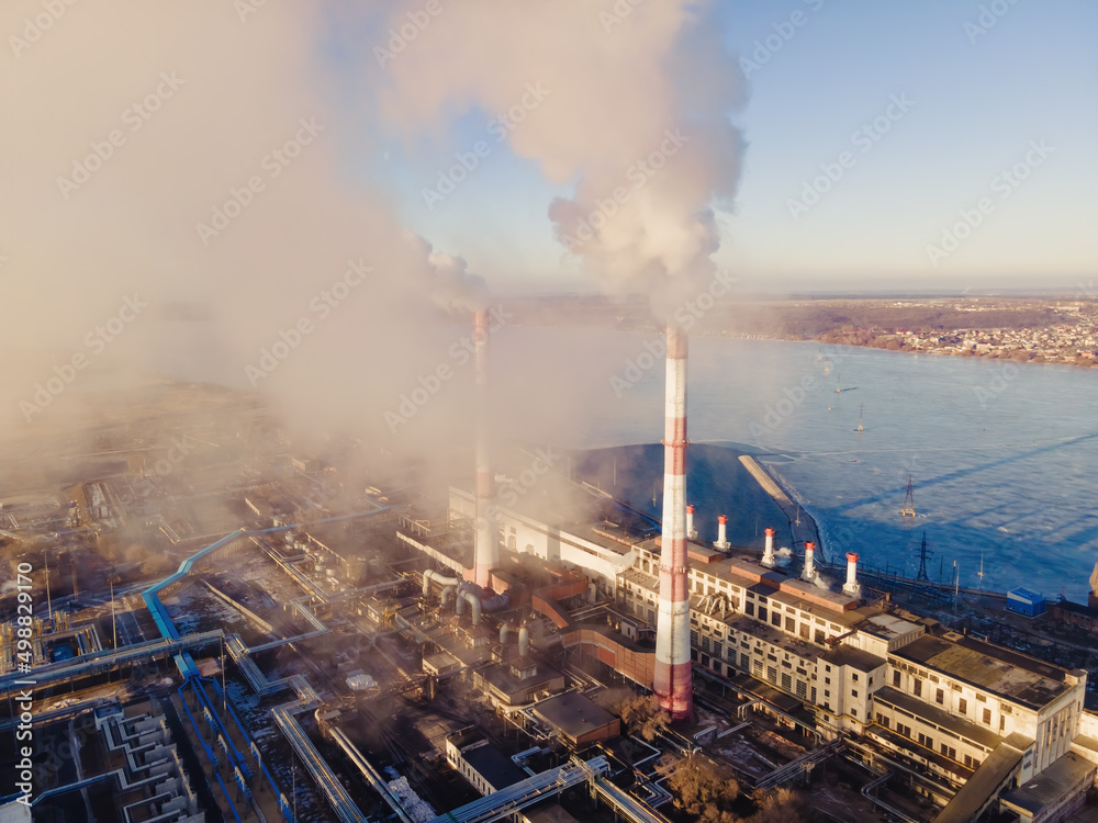 Industrial factory smokestack emission smoke from natural gas in atmosphere. Industry zone, factory smoke plumes. Global energy crisis