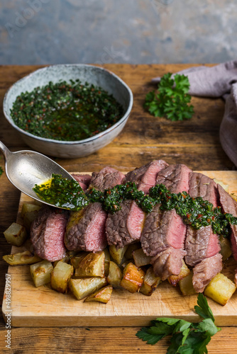 Steak and chimichurri on a bed of cubed potatoes