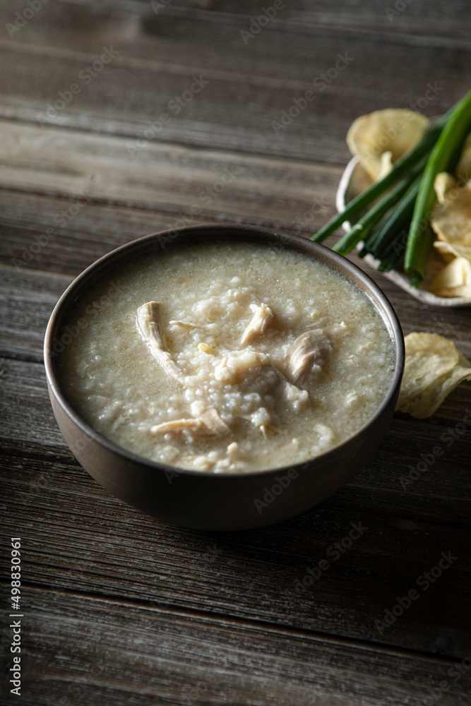 Steamy bowl of Chicken Jook in a rustic kitchen Steamy bowl of Chicken Jook in a rustic kitchen