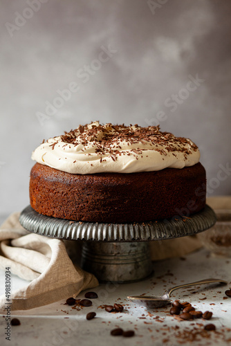 An uncut Irish coffee cake topped with whipped cream and grated chocolate. photo