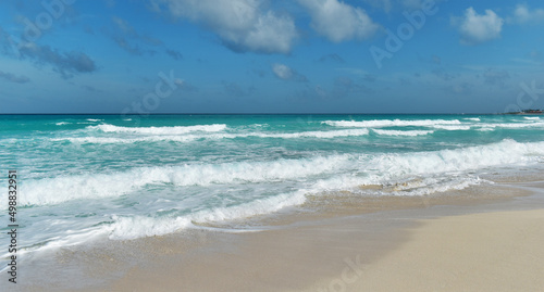 Sandy shore  beach and turquoise sea  big waves  Caribbean  Cancun  Yucatan  Mexico.